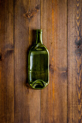 Empty bottle on wooden background top view