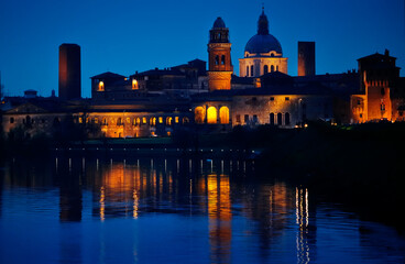 Nighttime Verona. Italy. View at old town with river. Blue hour. Picturesque cityscape.