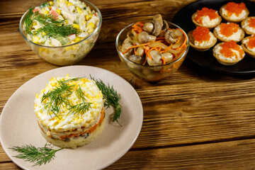 Set of various festive dishes on a wooden table