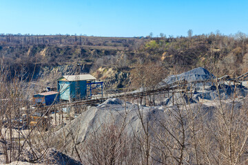 Rock crusher machine, crushing machinery, conveying crushed granite gravel stone in a granite quarry. Processing plant for crushed stone and gravel. Mining equipment
