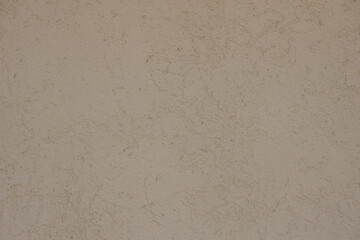 White concrete wall with stucco relief pattern.