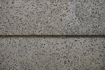 Close up a lot of small or tiny stones that are mixed with cement. The surface of concrete wall,...