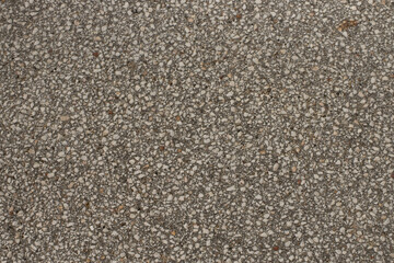 Close up a lot of small or tiny stones that are mixed with cement. The surface of concrete wall,...