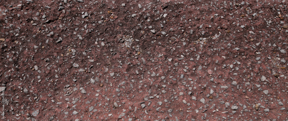Wall mural close up a lot of small or tiny stones that are mixed with cement. the red surface of concrete wall,