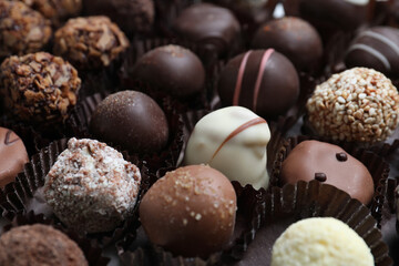 Different tasty chocolate candies as background, closeup