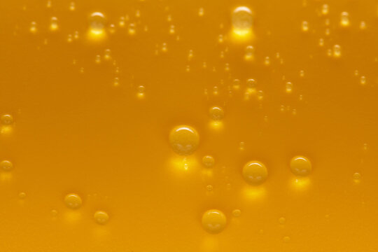 Golden water drops on an yellow background. For creative banner design with copy space for a text. Selective focus