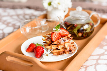 Delicious fresh baked belgian waffles with berries and fruit