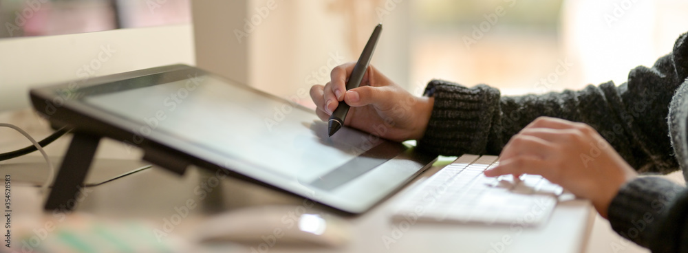 Fototapete graphic designer working with drawing tablet and computer keyboard