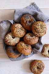An assortment of homemade fresh bagels with different toppings. American breakfast pastry.