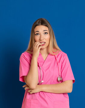 Blonde doctor with pink uniform