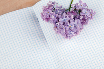 Lilac flowers on a squared exercise-book