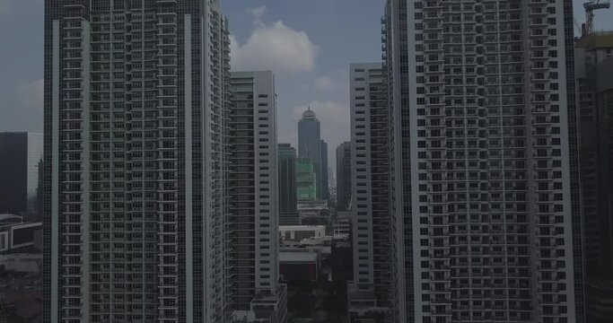 Ungraded, Straight aerial flight between residence buildings towards business district. Urban view. Drone, 4K. 