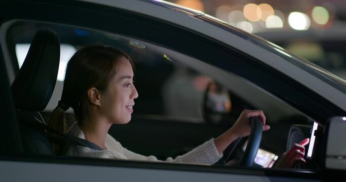 Woman drive a car and use gps on cellphone