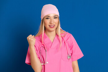 Young doctor with a pink uniform and a scarf