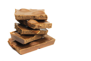 Tower, a stack of milk chocolate chunks with nuts isolated on white
