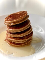 stack of pancakes with honey syrup