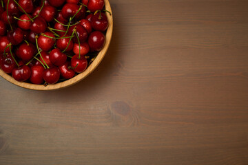 Green spring red cherries on wooden background selective focus cherry
