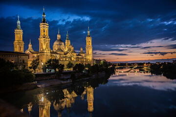 Cathedral-Basilica of Our Lady of the Pillar with evening lights,  Roman Catholic church in the city of Zaragoza, Aragon 