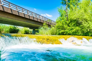  Croatia, river Mreznica, beautiful waterfall and wooden bridge, green countryside landscape in Karlovac region © ilijaa