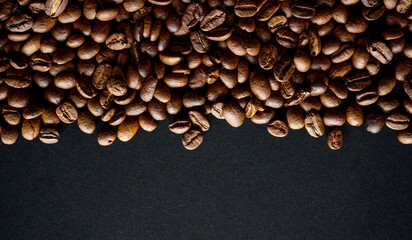 coffee beans on black background with copy space