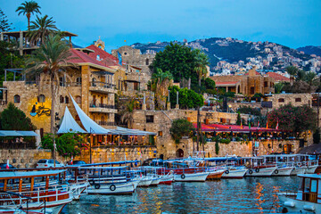 Historical houses and boats in the old port of Byblos, Lebanon - obrazy, fototapety, plakaty