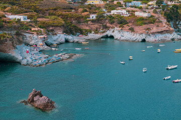 Fototapeta premium View of the harbor and port at Ponza island in the summer season. The place is typical for its blue water and colorful houses. Ponza is the largest island of the Italian Pontine Islands archipelago. 
