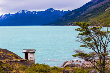 Small white abandoned house on the shore of Argentino Lake (Lago Argentino) close to Perito Moreno Glacier,  El Calafate, Patagonia Argentina
