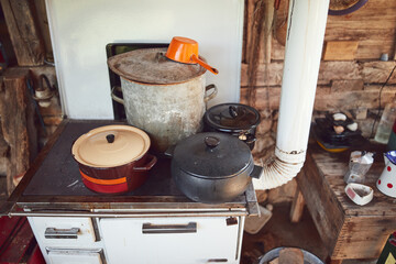 Old stove with pots used for cooking food on a traditional old way.