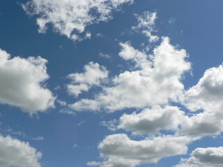Obraz premium Beautiful blue sky with clouds background. Sky clouds. Air and fluffy clouds in the blue sky on a sunny day, background texture. Copy space. The concept of hope.