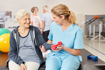 Senior woman doing dumbbell workout with therapist