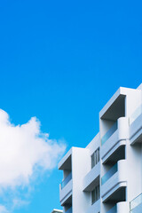 Fragment of white building against blue sky with copy space