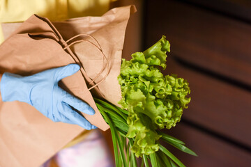 Obraz premium little girl with laptop. young woman holding blank sign. Coronavirus. Woman with face mask on quarantine, cooks in the kitchen at home during coronavirus crisis. Stay at home. Enjoy cooking at home. 