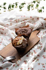 two cupcakes on a wooden board on a light background

