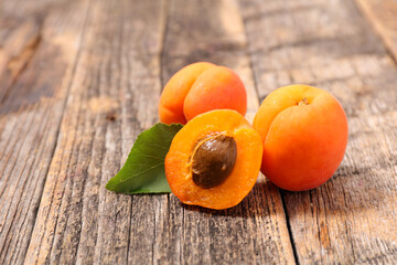 fresh apricot and leaf on wood background