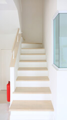 Wooden staircase in the new house with fire extinguisher installation