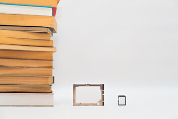 Stack of books, hard disk drive and memory card, improving technology. Storage data, compressed...