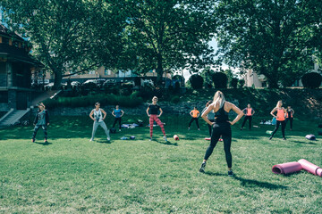 Women workout on in the yard of women trainers. Fitness on the street