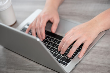 Fototapeta na wymiar Female hands using laptop