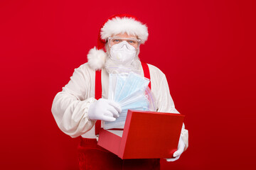 Photo of old merry santa courier worker packing box flu medical respirators epidemic protection internet website order wear goggles face mask hat shirt suspenders isolated red background