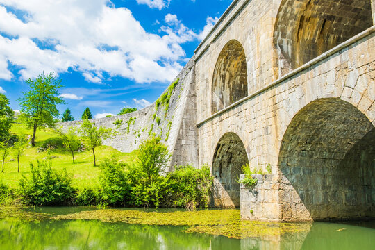 Croatia, beautiful 19 century stone bridge with arches in Tounj on Tounjcica river