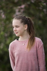 Young teenage teen girl in nature in the countryside summer portrait.