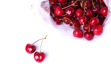 Obraz na płótnie Canvas dark red cherries, close up shot, isolated on white