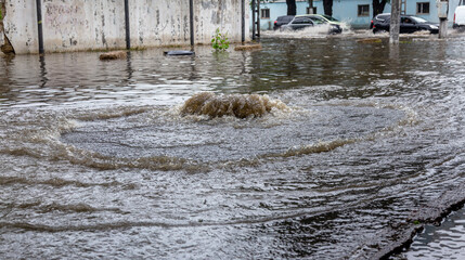 Вriving car on flooded road during flood caused by torrential rains. Cars float on water, flooding...