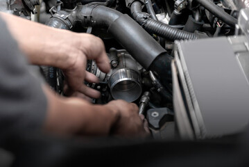 Fototapeta na wymiar Car mechanic working on engine repair