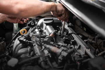 Fototapeta premium Car mechanic working on engine repair