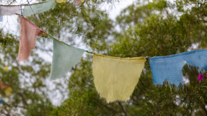 Weathered tibetan prayer flags on a string. At Nanputuo Temple, Xiamen