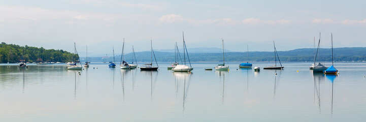 Panorama with anchoring sailboats and small yachts at Ammersee (Lake Ammer)