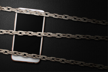 Chain fence locking smartphone on black background