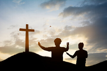 Silhouette family looking for the cross of Jesus Christ on autumn sunrise background. - obrazy, fototapety, plakaty