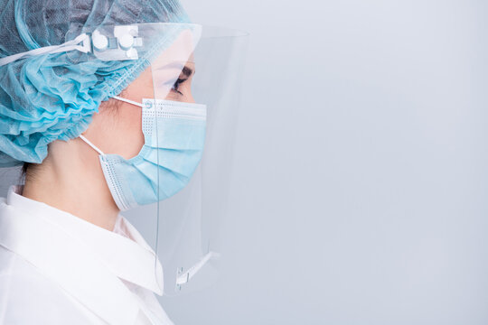 Closeup profile photo of virologist doctor lady sterile uniform look side empty space wear lab white coat mask facial plastic protection surgical cap hat isolated grey background